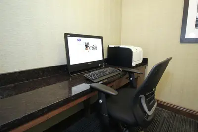 a desk with a laptop computer and a printer at Hampton Inn Sandusky-Central in Sandusky