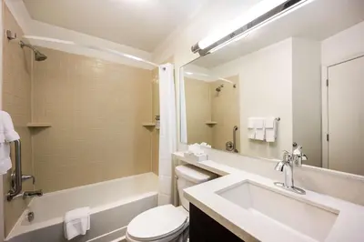 a bathroom with a sink and a tub and a toilet at Sonesta Simply Suites Pittsburgh Airport in Imperial