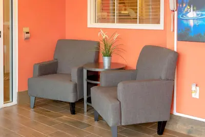 two chairs and a table in a waiting room at Sonesta Simply Suites Pittsburgh Airport in Imperial