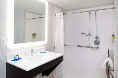 a white bathroom with a sink and a shower at Holiday Inn Express Cincinnati West by IHG in Dent