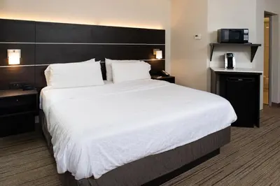 a large white bed in a hotel room at Holiday Inn Express Cincinnati West by IHG in Dent