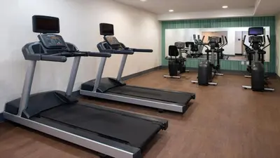 a gym with several treadmills and a treadmill at Holiday Inn Express Cincinnati West by IHG in Dent