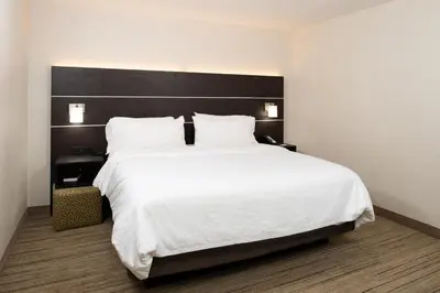 a bedroom with a large white bed with a black headboard at Holiday Inn Express Cincinnati West by IHG in Dent