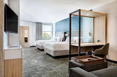 a hotel room with two beds and a television at SpringHill Suites by Marriott Cleveland Independence in Independence