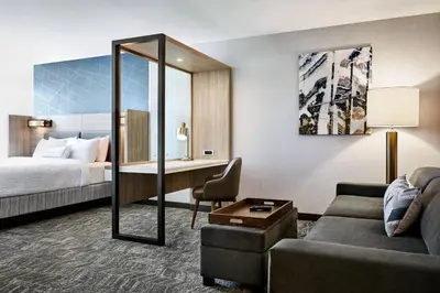 a hotel room with a bed and a desk at SpringHill Suites by Marriott Cleveland Independence in Independence