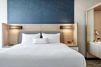a bedroom with a white bed and a blue wall at SpringHill Suites by Marriott Cleveland Independence in Independence