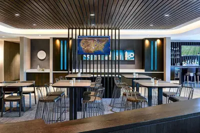 a restaurant with tables and chairs and a map on the wall at SpringHill Suites by Marriott Cleveland Independence in Independence