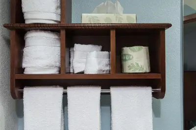 a bunch of towels on a shelf in a bathroom at The Hotel at Dayton South in Dayton
