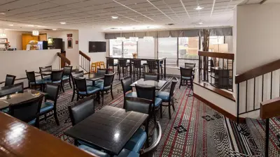 a restaurant with tables and chairs in a room at The Hotel at Dayton South in Dayton