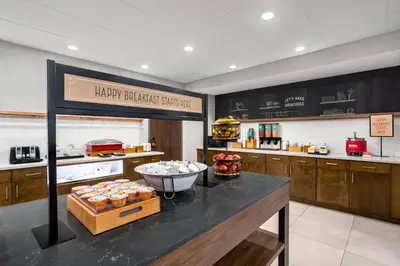 a kitchen with a counter with some food on it at Hampton Inn & Suites Muncie in Muncie