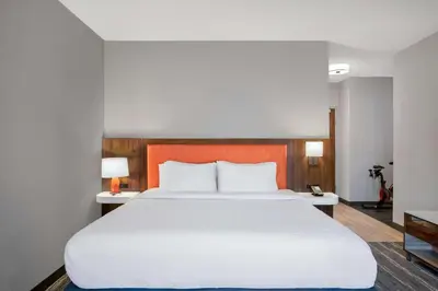 a bedroom with a large white bed and two lamps at Hampton Inn & Suites Muncie in Muncie