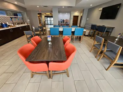 a dining room with a table and chairs at Holiday Inn Express Hotel & Suites Cincinnati-Blue Ash by IHG in Blue Ash