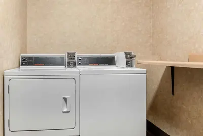 a washer and dryer in a room at Quality Hotel Conference Center Cincinnati Blue Ash in Blue Ash