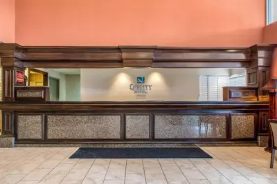a front desk of a dental office with a mirror at Quality Hotel Conference Center Cincinnati Blue Ash in Blue Ash