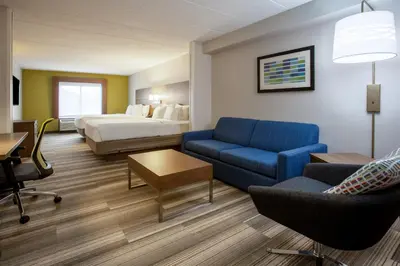 a hotel room with a couch and a bed at Holiday Inn Express Hotel & Suites Fort Wayne by IHG in Fort Wayne