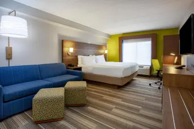 a hotel room with a bed and a couch at Holiday Inn Express Hotel & Suites Fort Wayne by IHG in Fort Wayne