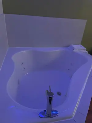 a white bath tub with a candle in it at Willow Lodge Willoughby Cleveland in Willoughby