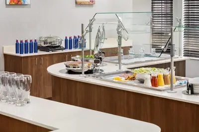 a buffet line in a restaurant with food on it at Staybridge Suites Fort Wayne by IHG in Fort Wayne