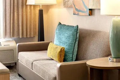 a living room with a couch and a pillow at Staybridge Suites Fort Wayne by IHG in Fort Wayne