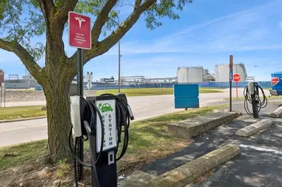 a row of parking meters next to a tree at Motel 6-Milan, OH - Sandusky in Milan