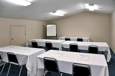 a room with white tables and chairs and a whiteboard at Motel 6-Milan, OH - Sandusky in Milan
