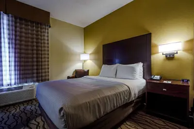 a hotel room with a large bed and a window at Quality Inn I-75 West Chester-North Cincinnati in West Chester