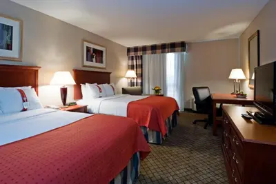 a hotel room with two beds and a television at Holiday Inn Cincinnati-Eastgate by IHG in Eastgate