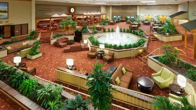 a large lobby with a hot tub in the middle at Holiday Inn Cincinnati Airport by IHG in Erlanger