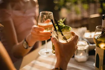 two hands holding a glass of wine at Holiday Inn Cincinnati Airport by IHG in Erlanger