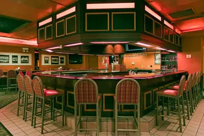 a bar in a restaurant with chairs around it at Holiday Inn Cincinnati Airport by IHG in Erlanger