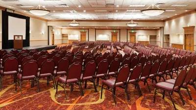 an empty room with a row of chairs in a hall at Holiday Inn Cincinnati Airport by IHG in Erlanger