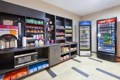 a grocery store aisle with two refrigerators at Candlewood Suites Washington North by IHG in Washington