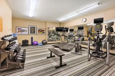 a gym with cardio equipment in a hotel room at Candlewood Suites Washington North by IHG in Washington