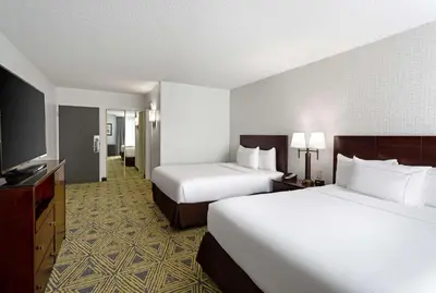 a hotel room with two beds and a flat screen tv at DoubleTree by Hilton Washington Meadow Lands Casino Area in Washington