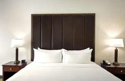 a bedroom with a large bed with white pillows and two lamps at DoubleTree by Hilton Washington Meadow Lands Casino Area in Washington