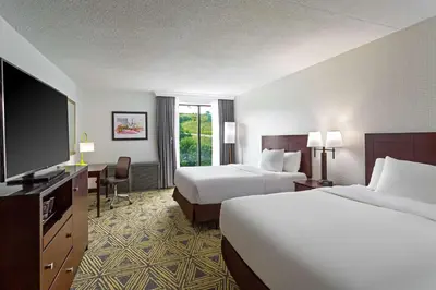 a hotel room with two beds and a flat screen tv at DoubleTree by Hilton Washington Meadow Lands Casino Area in Washington