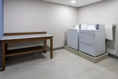 a kitchen with a white stove and a counter at Holiday Inn Express Hotel & Suites Center Township by IHG in Monaca