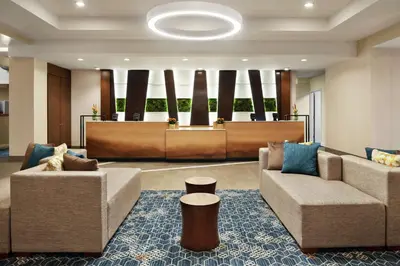 a lobby with two couches and a waiting room at Embassy Suites Cincinnati - RiverCenter in Covington