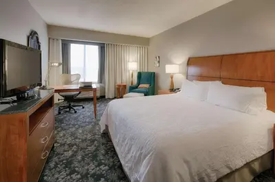 a hotel room with a bed and a desk and a television at Hilton Garden Inn Cleveland/Twinsburg in Twinsburg