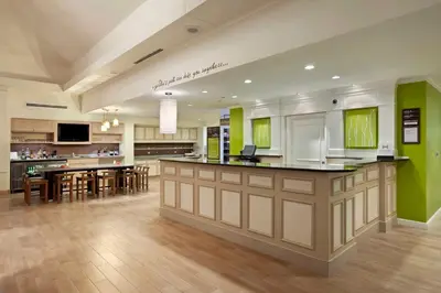 a large kitchen with green walls and wooden floors at Hilton Garden Inn Cleveland/Twinsburg in Twinsburg