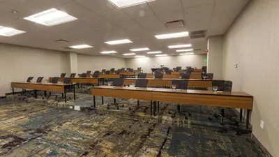 an empty room with desks and chairs in it at Holiday Inn Cleveland - South Independence by IHG in Independence
