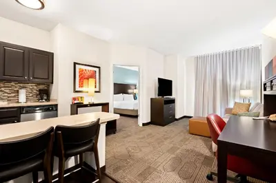a hotel room with a kitchen and a living room at Staybridge Suites - Cincinnati North by IHG in West Chester