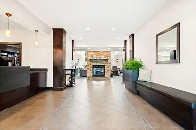 a lobby of a hotel with a fireplace at Staybridge Suites - Cincinnati North by IHG in West Chester