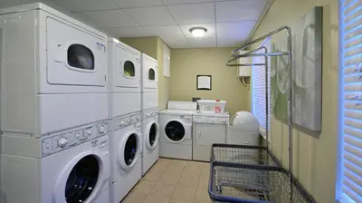 a laundry room with washing machines and a washer and dryer at Staybridge Suites - Cincinnati North by IHG in West Chester