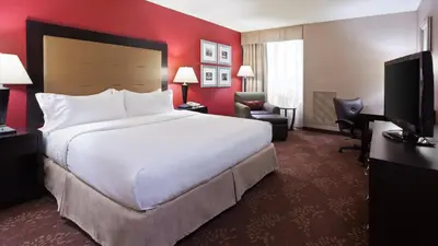 a hotel room with a large bed and a television at Holiday Inn Cincinnati-Riverfront by IHG in Covington