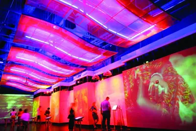 a group of people standing in a room with colored lights at Holiday Inn Cincinnati-Riverfront by IHG in Covington