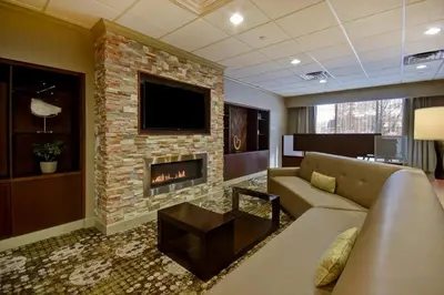 a living room with a couch and a fireplace at Holiday Inn Cincinnati-Riverfront by IHG in Covington
