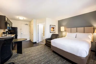 a hotel room with a large bed and a desk at Sonesta Simply Suites Cleveland North Olmsted Airport in North Olmsted