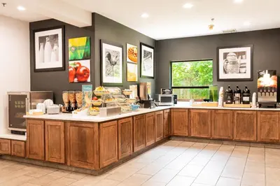 a coffee shop with a counter in a room at Quality Inn & Suites Oakwood Village - Cleveland South in Oakwood