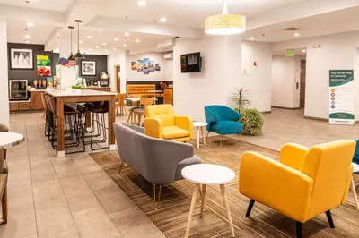 a waiting room with colorful chairs and tables at Quality Inn & Suites Oakwood Village - Cleveland South in Oakwood